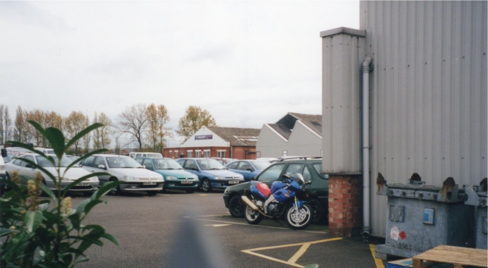 In the centre of this photograph is a building bearing a sign reading "Peugeot Sport". This is the Competitions Department.